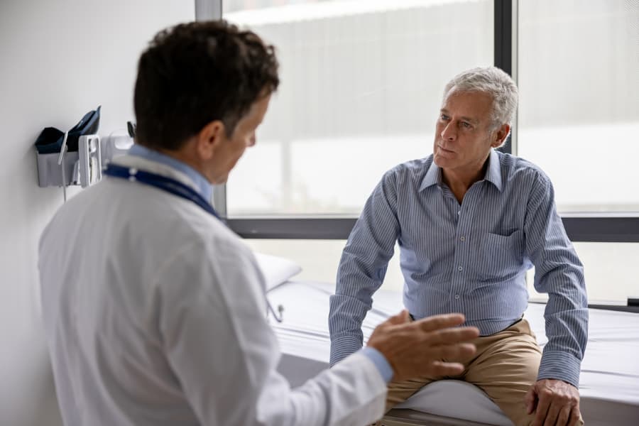 Physician speaking with patient about treatment options for urologic condition 