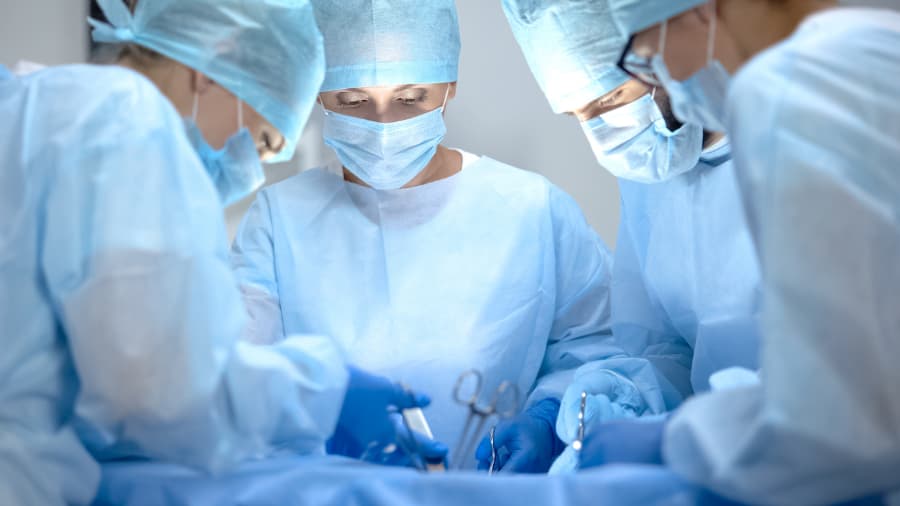 Surgical operating team performing thoracic surgery