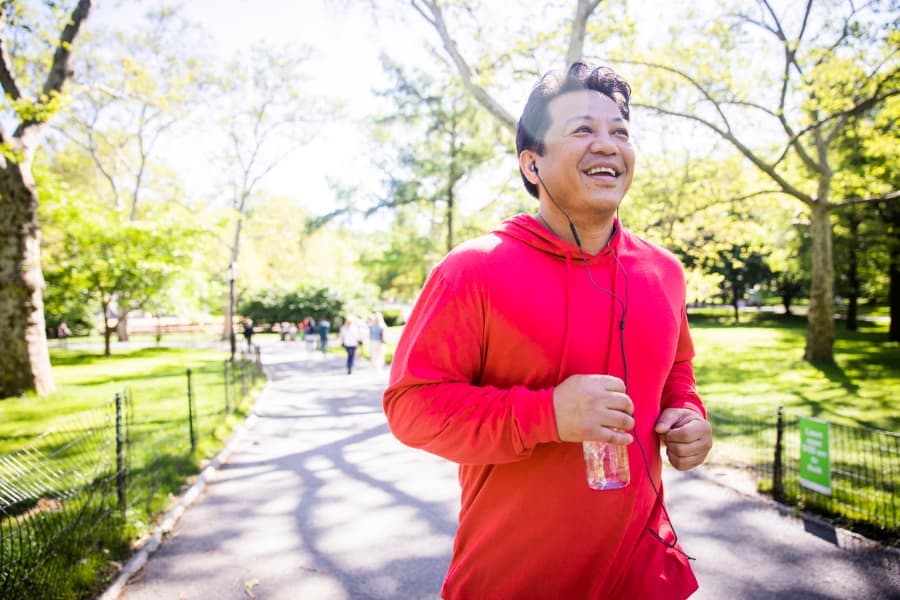 Man running outdoors in sunny weather