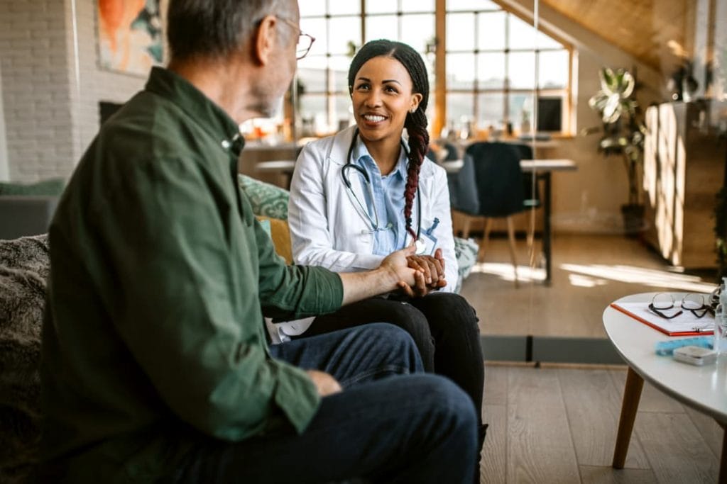 Physician Consults With Palliative Care Patient