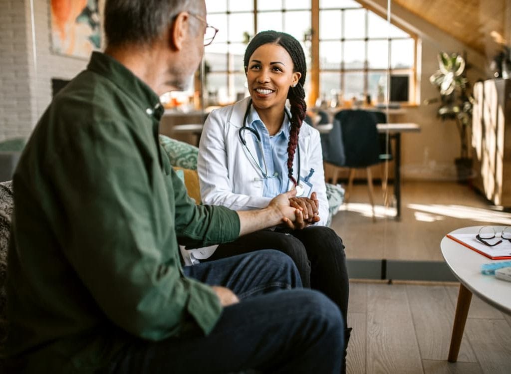 Physician Consults With Palliative Care Patient
