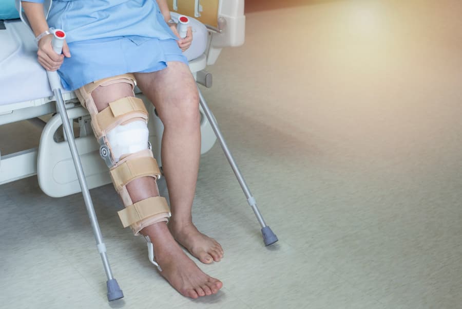 A patient wears a knee brace