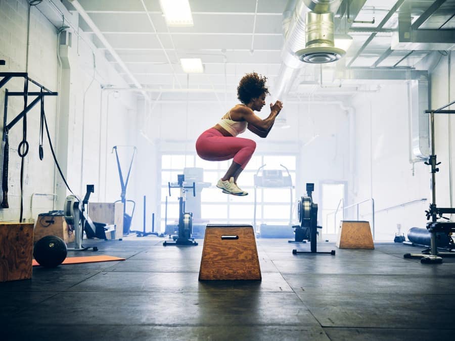 A woman jumps in a cross-training gym