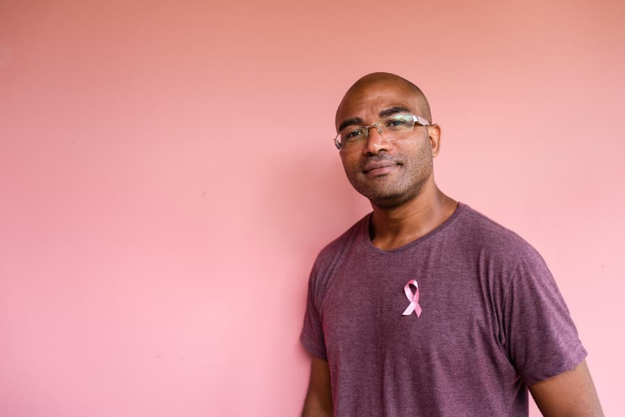 Male breast cancer patient with pink ribbon on shirt