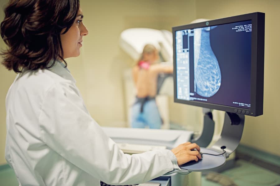 Physician working with mammography X-ray scanner