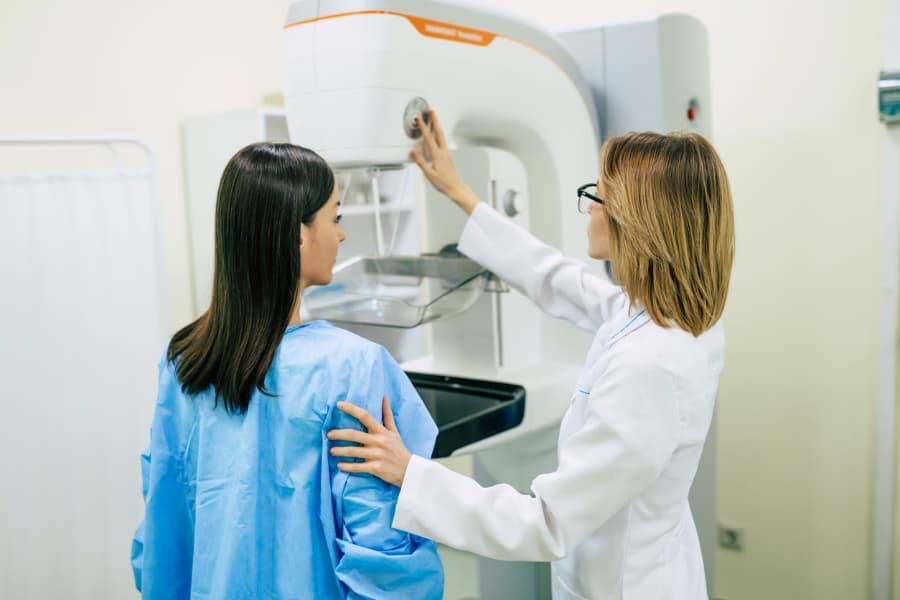 Doctor Providing a Mammogram To A Young Patient