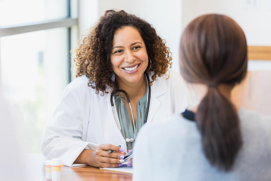 Doctor smiling while discussing health with patient