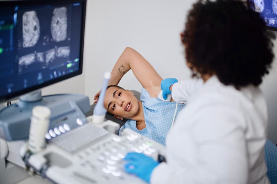 Patient undergoing ultrasound exam to check for breast cancer